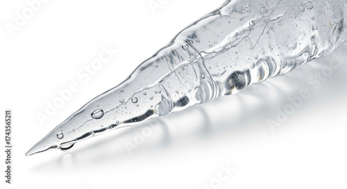 Closeup of an icicle isolated on white background, a tapering spike of ice formed when water freezes as it drips or flows
