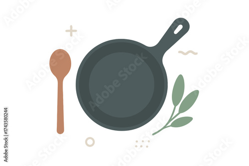 Stylized flat lay composition of cooking utensils including a cast iron pan and wooden spoon