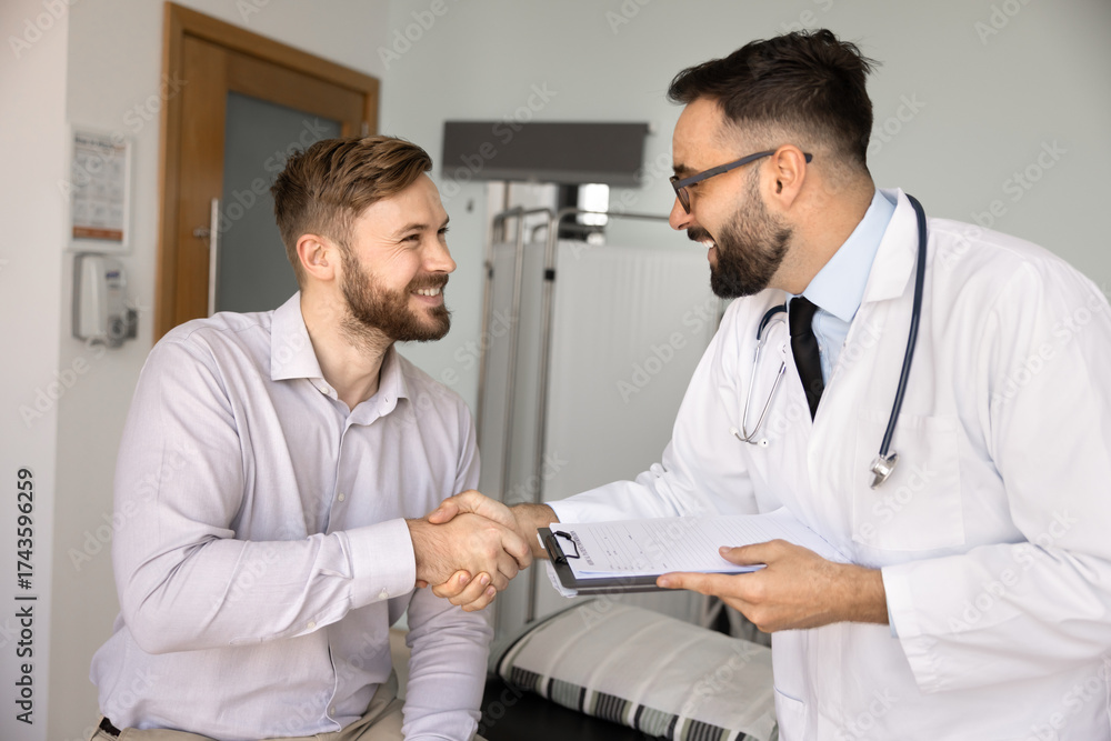 Fototapeta premium Handshake between satisfied patient and qualified male doctor