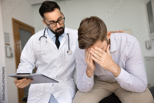 Fotografie Compassionate doctor touch shoulder, provide reassurance to concerned male patie