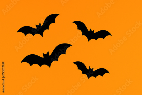 Flying Black Bats Silhouettes on Bright Orange Background - Halloween and Spooky Night Theme