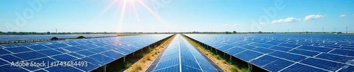 Expansive Solar Power Plant Rows of Photovoltaic Panels Stretch to the Horizon Under a Clear Blue Sky, Showcasing Clean, Renewable Energy and Sustainable Technology