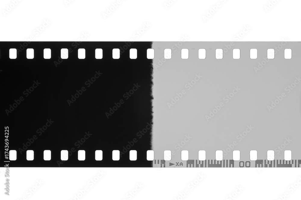 Fototapeta premium Film strip showing a contrasting transition from black to white with visible perforations isolated. Transparent PNG image.