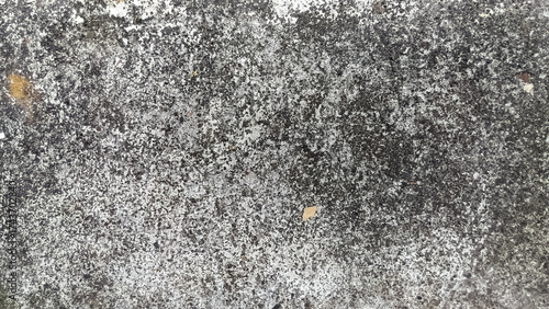 Grungy weathered concrete surface, textured with a mix of dark and light tones