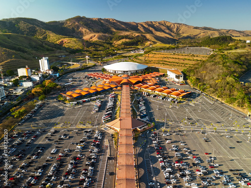 aerial view of the Basilica of the National Shrine of Our Lady Aparecida in Brazil during sunrise with mountains and greenery at distance