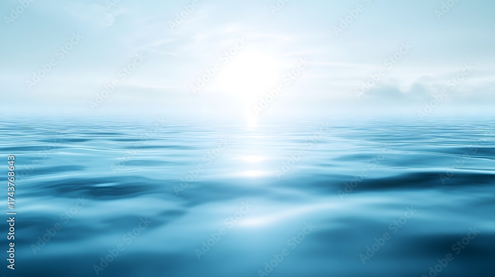 Fototapeta premium Gentle ocean waves reflect a bright, hazy sky.