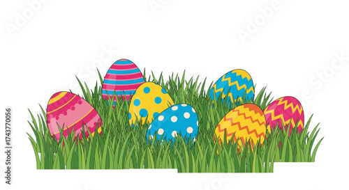 Colorful decorated Easter eggs hidden in fresh green grass.