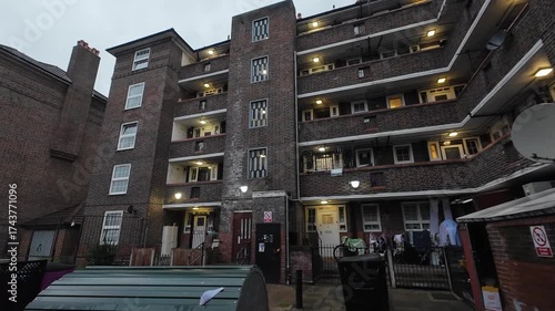 A pan clip of a government social housing estate in London of a dated construction during a grey Autumn late afternoon.
