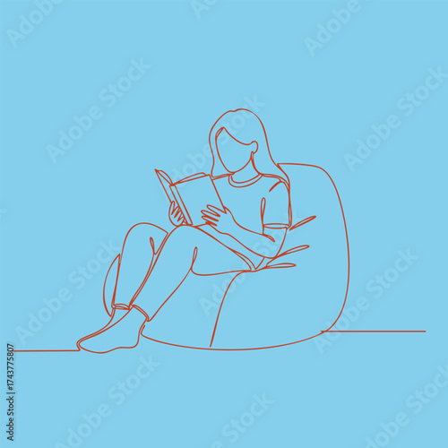 Person Relaxing on Bean Bag Chair Reading a Book in a Cozy Indoor Environment