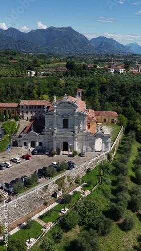 Wallpaper Mural Panoramic drone footage of Castello di Polpenazze and Chiesa Parrocchiale della Natività della Madonna, Italy. Historic medieval castle and scenic Lake Garda views. Torontodigital.ca