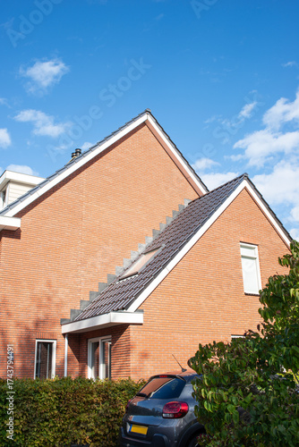 The architecture of modern building of typical red brick cottage on the street in a European city
