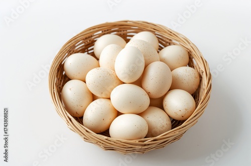 Wallpaper Mural Stack of fresh small eggs in a woven container on a plain white surface Torontodigital.ca