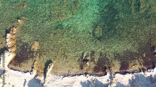 Wallpaper Mural Scenic aerial shot of a remote Sardinian cove, where crystal-clear turquoise water meets rocky shores, creating a private and untouched getaway for beach lovers and adventurers alike. Torontodigital.ca