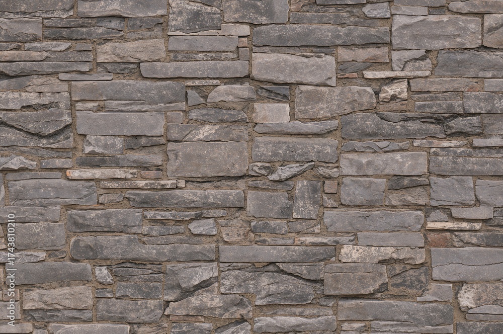 Fototapeta premium Contemporary textured stone brick wall designed as a backdrop.