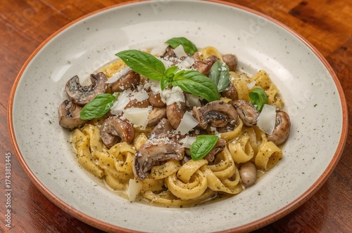 Midday meal featuring Mediterranean dishes: Pasta with assorted wild mushrooms, creamy cheese blend, fresh basil, and parmesan cheese.