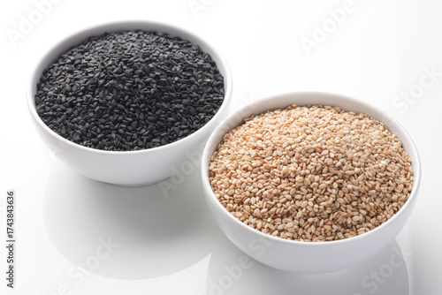 Indian food or seeds called sesame white and black in bowl isolated on white background  