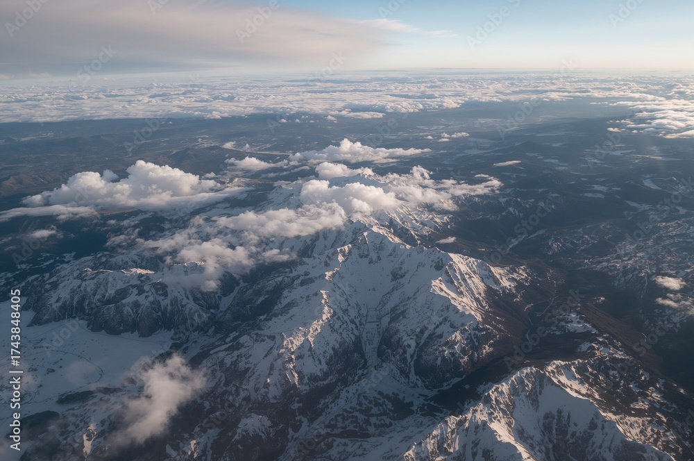 Fototapeta premium Aerial perspective of cloud-covered peaks and horizon
