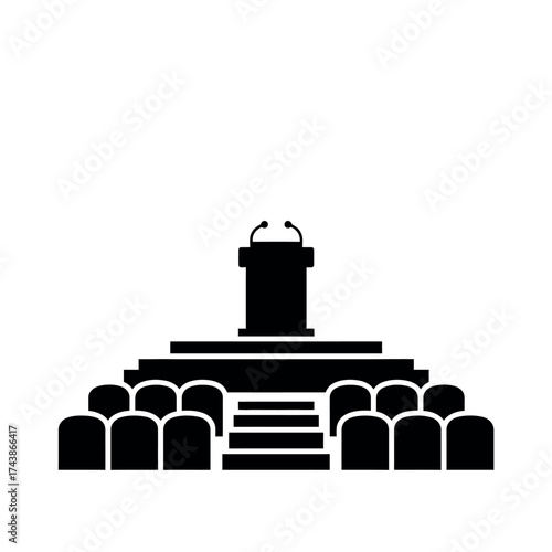 Podium with microphones and audience seats in a presentation hall.