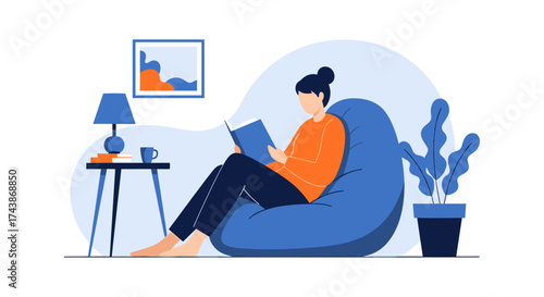 A young woman enjoys a peaceful moment reading a book while relaxing in a comfortable beanbag chair at home.