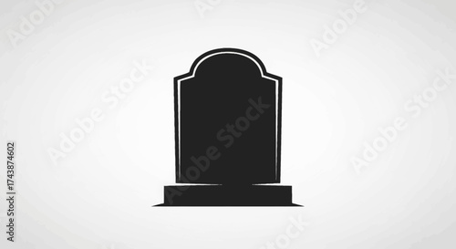 A simple, black gravestone stands centered against a plain, light gray background.