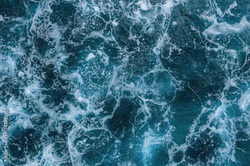 Aerial perspective of dynamic sea waves with white froth. Ideal for backgrounds, prints, and artistic creations.
