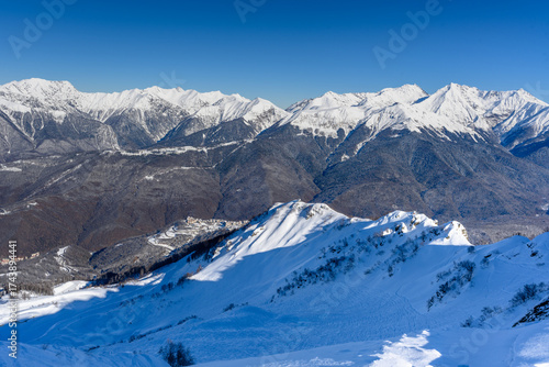 Wallpaper Mural Mountainside, valley. In the background there are beautiful snow-capped mountains and an opening view of the valley. The bright winter sun highlights the snow-white landscapes. Torontodigital.ca