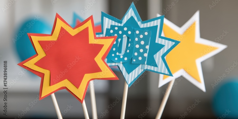 Fototapeta premium Colorful star-shaped decorations on sticks, perfect for celebrating events or parties, adding a festive touch to any occasion.