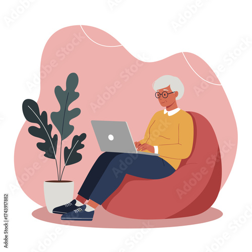 Relaxed senior woman using laptop on bean bag connecting online from home