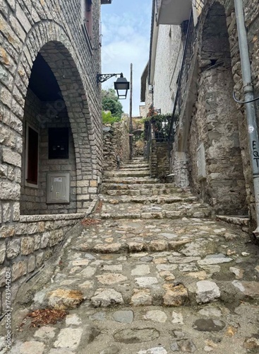 Vintage narrow street with old stone buildings, warm tones, and nostalgic atmosphere of a small European town.