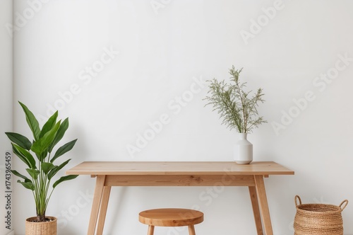 Minimalist wooden desk with a plant and vase in a bright room setting