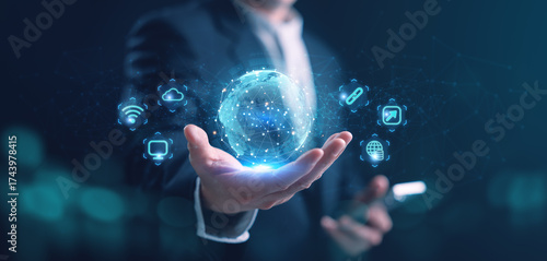 Businessman holding holographic digital globe with network icons, cloud computing, and global connection concept. Futuristic technology, innovation, data exchange, and communication background.