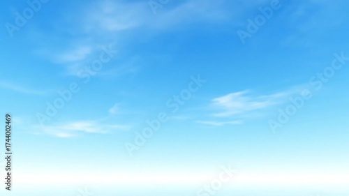 Gentle clouds drift across vibrant blue sky offering peace and tranquility