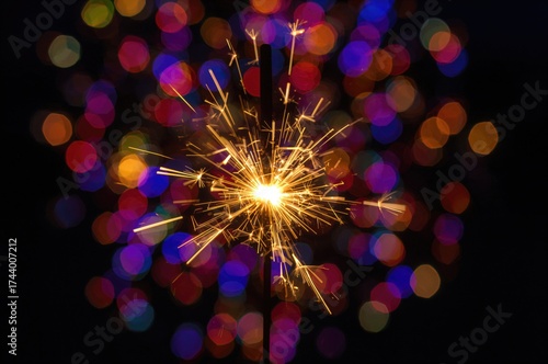 A sparkler glows brightly a...
