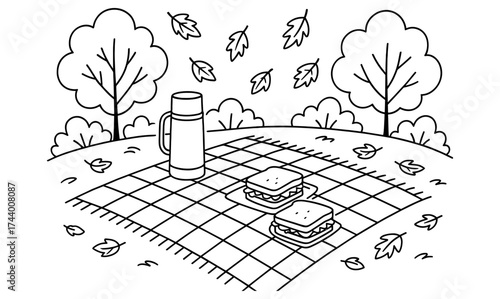 Autumn picnic scene with falling leaves and sandwiches on a checkered blanket