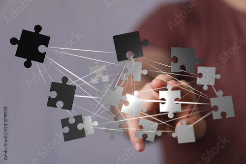 Hand arranging puzzle piece...