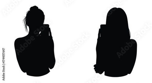 Silhouettes of two women taking photos with their mobile phones