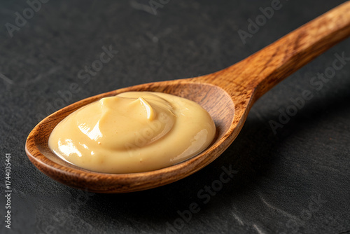 Creamy Mustard on Wooden Spoon: An inviting close-up presents a vibrant swirl of creamy mustard nestled within a rustic wooden spoon. It's a symphony of flavor waiting to be savored.