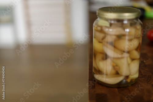 A jar of pickled apples sit...