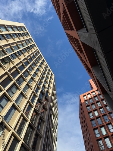 Looking up at modern buildings in Manchester city centre with a clear blue sky background. Modern Manchester architecture. Manchester England. 