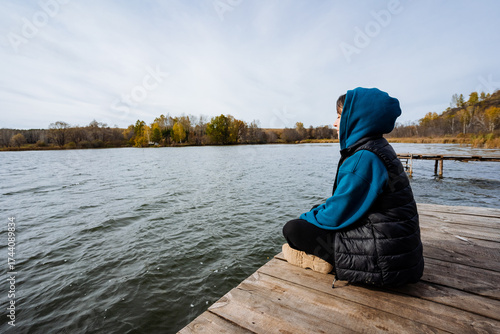 Bild auf Leinwand A Thoughtful Youth by the Tranquil Lake A Beautiful Moment of Reflection and Ser