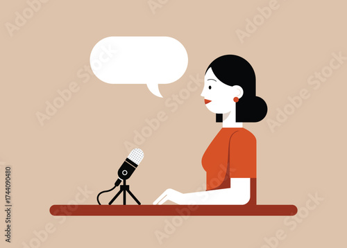 A professional woman speaking into a microphone at a table with an empty speech bubble above her