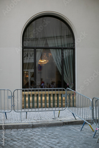Картината върху платно A sizable window adorned with colorful curtains and barriers positioned in front