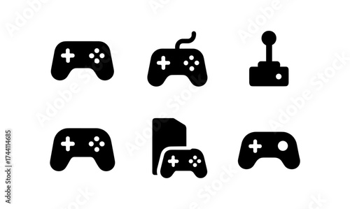 Classic black gaming icons set: gamepads and joystick collection in silhouette style