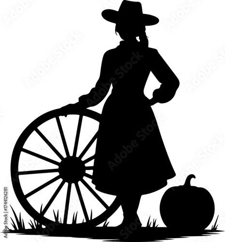 Silhouette of a Farm Girl Leaning on a Cartwheel Next to a Pumpkin