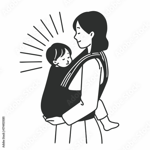 Mother holding baby in a sling with a happy expression
