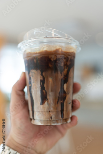 Wallpaper Mural Iced mocha coffee with chocolate drizzle on man hand Torontodigital.ca