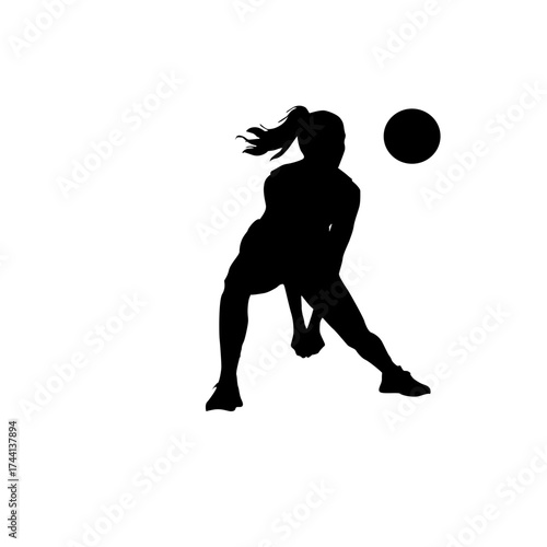 Silhouette of a female volleyball player in action hitting the ball during a game