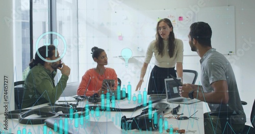 Analyzing data overlays, four professionals collaborating in boardroom with laptops, circuit boards