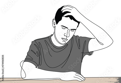 A distressed young man with his hand in his hair looking down with a worried expression