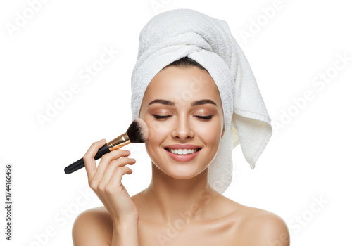 Smiling woman with towel on head applying makeup with brush isolated on transparent background, beauty and skincare routine PNG